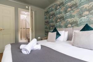 Un dormitorio con una cama grande con toallas. en Bridges Retreat, Newcastle, en Gateshead
