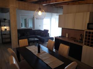 a living room with a table and a couch at Stan na dan BOVKA in Široki Brijeg +7 photos
