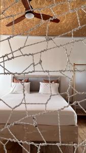 a bedroom with a bed made out of rope at Himara Hostel in Himare