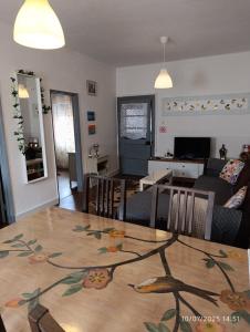 a living room and dining room with a table at West house in Vale Covo