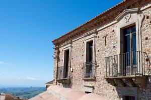 an old brick building with windows and balconies at B&B Kalòs experience in Bove