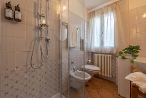 a bathroom with a shower and a toilet and a sink at Casa Orizzonte - Appartamento con vista in Gabicce Mare +21 photos