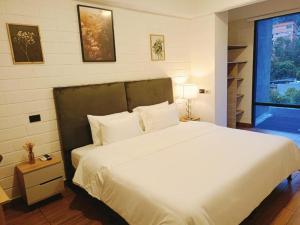 Ένα ή περισσότερα κρεβάτια σε δωμάτιο στο Hotel Poblado Boutique