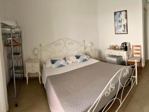 a bedroom with a large bed and two chairs at Alba b&b in Polignano a Mare