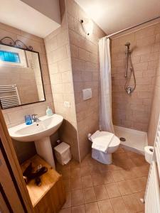 a bathroom with a sink and a toilet and a shower at Casa Vittoria in Dervio
