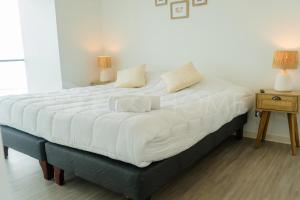 Postel nebo postele na pokoji v ubytování PRO HOME Balmaceda XI