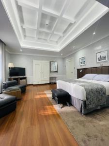 a large bedroom with a large bed and a television at Hotel Casagrande in Arequipa +65 photos