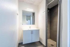 ein Badezimmer mit einem weißen Waschbecken und einer Dusche in der Unterkunft 824 Hvide Sande - Mamrelund 6 2. A in Hvide Sande + 23 Fotos