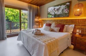 a bedroom with a bed and a large window at Malhada Jeri in Jericoacoara