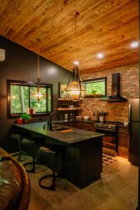 a kitchen with wooden ceilings and a large kitchen island at Whiskey Lounge in Loudonville