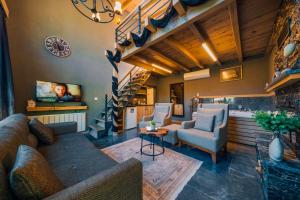 a living room with a couch and chairs and a tv at antik river house in Sile