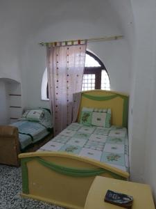a bedroom with two beds and a table in it at Ma Sou in El Alamein