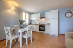 a kitchen and dining room with a table and chairs at Casa Orizzonte - Appartamento con vista in Gabicce Mare