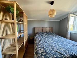 a bedroom with a bed and a book shelf at Apartment More in Košljun
