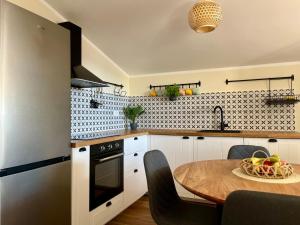 a kitchen with a table with a bowl of fruit on it at Apartment More in Košljun +11 photos