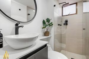 a white bathroom with a sink and a mirror at Ankara 302 - Clean Comfy Loft Trendy in Provenza in El Poblado