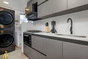 a kitchen with a sink and a dishwasher at Ankara 302 - Clean Comfy Loft Trendy in Provenza in El Poblado +10 photos