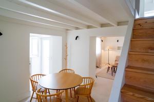 a dining room with a table and chairs at Castelo House in Castelo de Vide