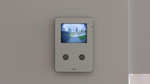 an ipod on a wall with a picture of a house at Modernes Ein-Zimmer-Apartment in Greifswald