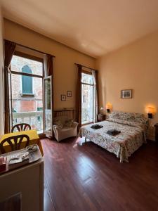 a bedroom with a bed and a large window at Bed and Breakfast Querini San Marco in Venice