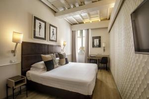 Posteľ alebo postele v izbe v ubytovaní Condotti Palace