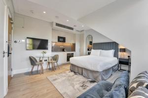 a bedroom with a bed and a table in a room at LuxLet Apartments - Heart of Hampstead, London in London +84 photos