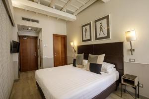 Posteľ alebo postele v izbe v ubytovaní Condotti Palace