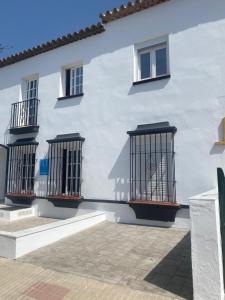 a white building with three bird cages on it at LEON 38 Apartments Private Parking - EaW Homes in Estepona