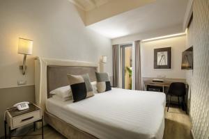 Posteľ alebo postele v izbe v ubytovaní Condotti Palace