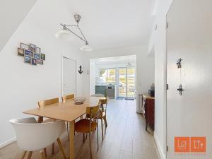 a dining room and kitchen with a table and chairs at Au Gré de la Mer in Wimille