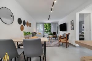 a dining room and living room with a table and chairs at Ankara 301 - Contemporary Loft Trendy in provenza in El Poblado