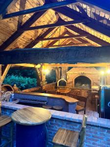 a restaurant with wooden tables and benches in a building at Forest Escape Banja Luka in Banja Luka