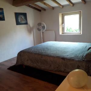 a bedroom with a bed and a window at Charming small house close to Uzès in Foissac +24 photos
