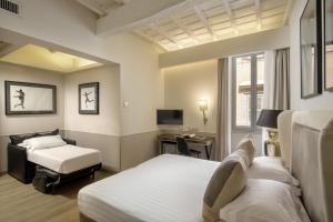 Posteľ alebo postele v izbe v ubytovaní Condotti Palace