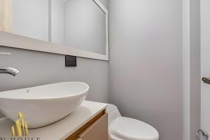 a white bathroom with a sink and a toilet at Aria Living 300 - Style and Urban Comfort in Guayaquil