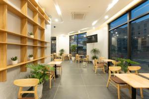 a restaurant with tables and chairs and windows at Ocean Hotel in Sầm Sơn