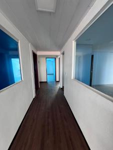 an empty corridor in an office building with a hallway at Liv Stay in Brasília