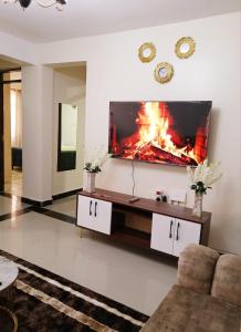 a living room with a fire in the wall at Kitengela two bedroom stays in Kitengela 