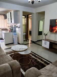 a living room with two tables and a couch at Kitengela two bedroom stays in Kitengela 