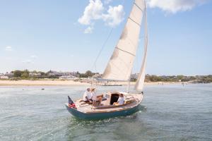 a group of people on a sail boat on the water at Chatham Bars Inn in Chatham