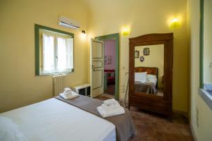 a bedroom with two beds and a mirror at Charming Rooftop Flat in City Center in Catania