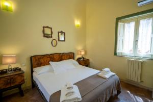 a bedroom with a bed with two towels on it at Charming Rooftop Flat in City Center in Catania +2 photos