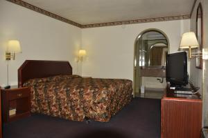 Ένα ή περισσότερα κρεβάτια σε δωμάτιο στο The Flamingo Motel San Jose