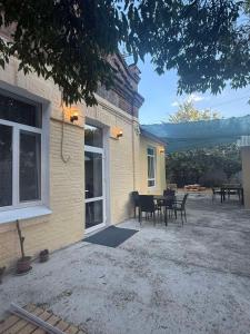 a patio with a table and chairs next to a house at Happy Home Hostel in Odesa