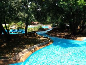 a water slide at a resort with blue water at Charming small house close to Uzès in Foissac