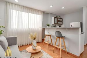 a living room with a couch and a table at Aria Living 500 - Modern with Private Terrace in Guayaquil