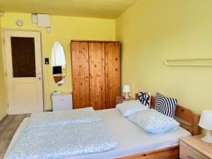 a bedroom with a bed with two pillows on it at Sailor's Apartman in Siófok