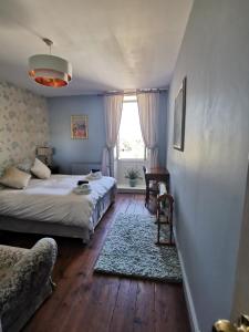 a bedroom with two beds and a couch and a window at Maison la tour in Néré +91 photos
