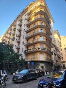a large building with cars parked in front of it at Maison de luxe in Naples +16 photos