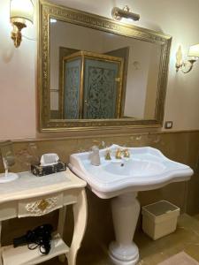 a bathroom with a white sink and a mirror at Maison de luxe in Naples